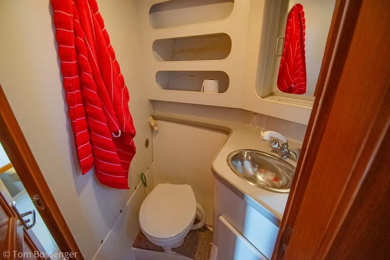 Slide: The Image of Bathroom interior of 1994 Carver 370 Aft Cabin Motor Yacht with red towel and sink. - 31