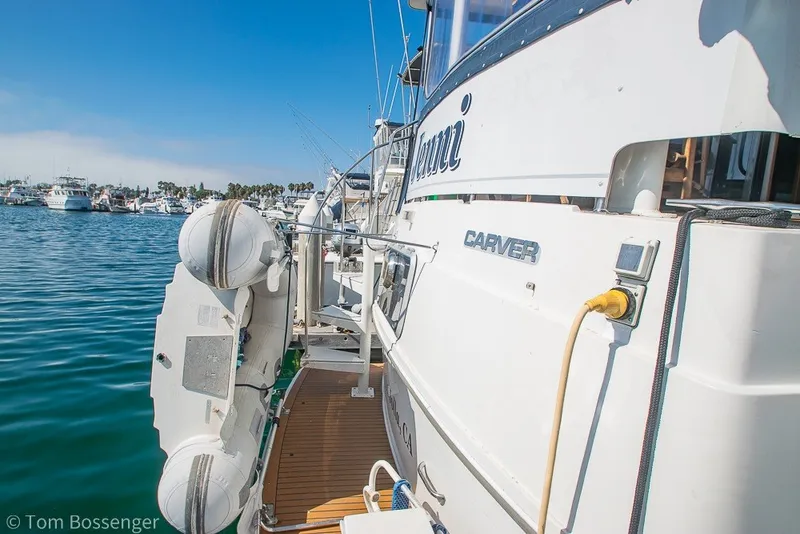Slide: The Image of 1994 Carver 370 Aft Cabin Motor Yacht docked in a marina, sunny day. - 6