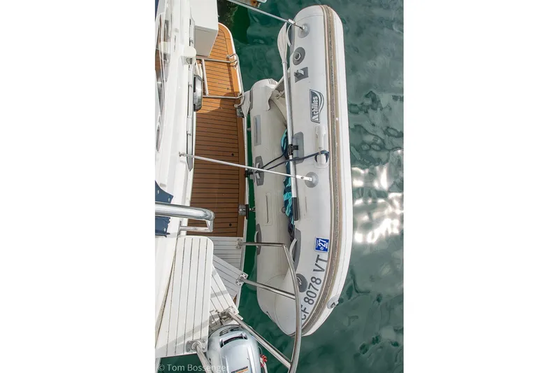 Slide: The Image of 1994 Carver 370 Aft Cabin Motor Yacht with attached inflatable dinghy on water. - 43