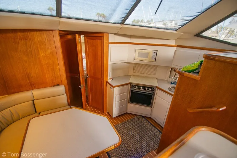 Slide: The Image of Interior of 1994 Carver 370 Aft Cabin Motor Yacht with kitchen and seating area. - 16