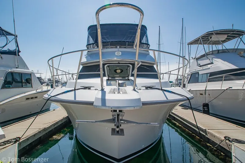 Slide: The Image of 1994 Carver 370 Aft Cabin Motor Yacht docked at marina, front view. - 3