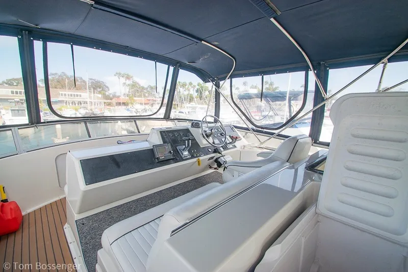 Slide: The Image of 1994 Carver 370 Aft Cabin Motor Yacht helm with panoramic marina view. - 35