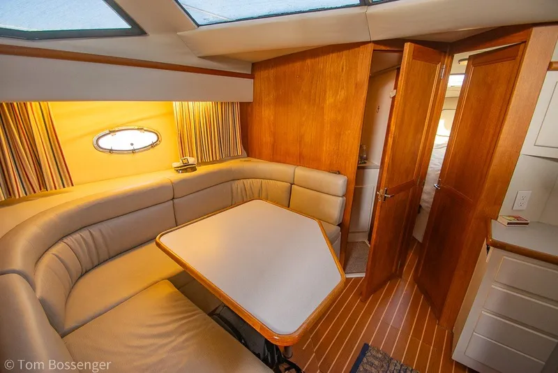 Slide: The Image of Interior of 1994 Carver 370 Aft Cabin Motor Yacht with cozy seating and wooden accents. - 17