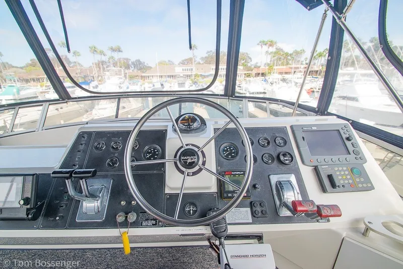 Slide: The Image of Helm of 1994 Carver 370 Aft Cabin Motor Yacht with steering wheel and navigation controls. - 38