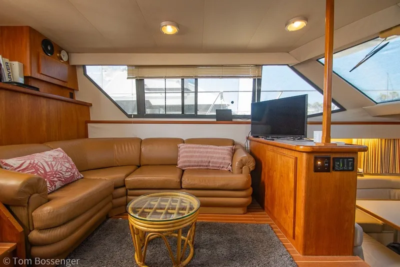 Slide: The Image of Interior of 1994 Carver 370 Aft Cabin Motor Yacht with leather seating and TV. - 12