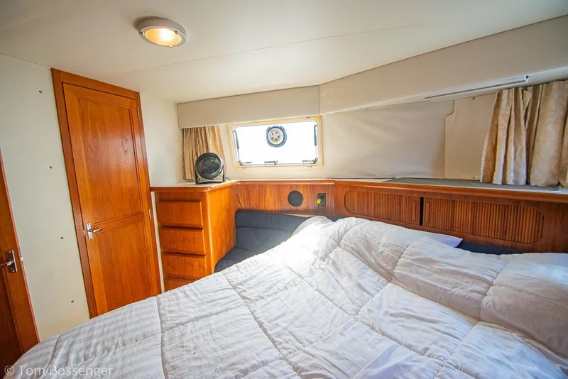 Slide: The Image of Cozy cabin interior of 1994 Carver 370 Aft Cabin Motor Yacht with wood accents. - 24