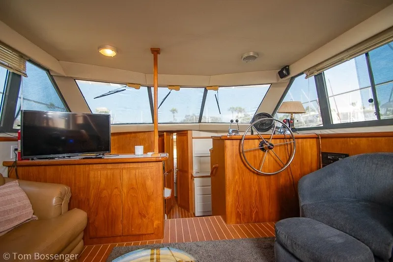 Slide: The Image of Interior of 1994 Carver 370 Aft Cabin Motor Yacht with helm, TV, and seating area. - 15