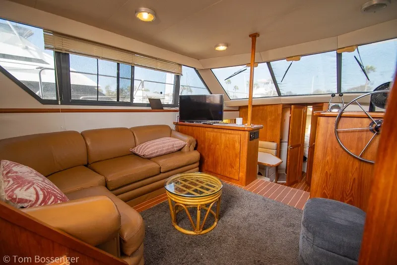 Slide: The Image of Interior of 1994 Carver 370 Aft Cabin Motor Yacht with cozy seating and wooden accents. - 10