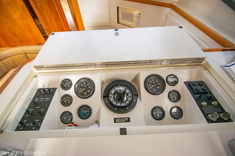 Slide: The Image of Control panel of a 1994 Carver 370 Aft Cabin Motor Yacht with gauges and switches. - 46