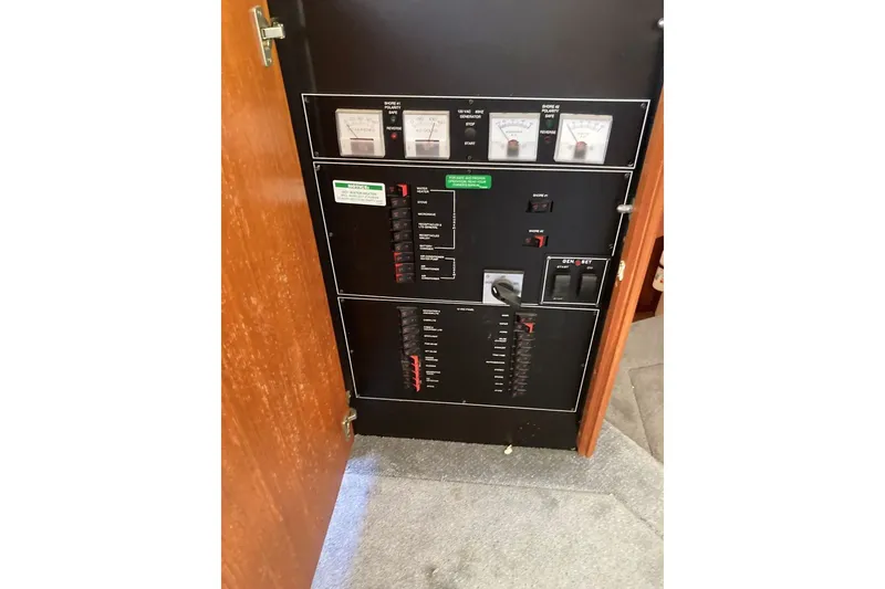 Slide: The Image of Electrical panel inside 1996 Carver 355 Aft Cabin Motor Yacht, featuring gauges and switches. - 15