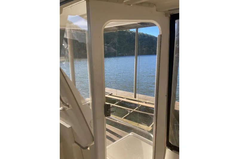 Slide: The Image of View from 1996 Carver 355 Aft Cabin Motor Yacht, overlooking serene waters and lush shoreline. - 14