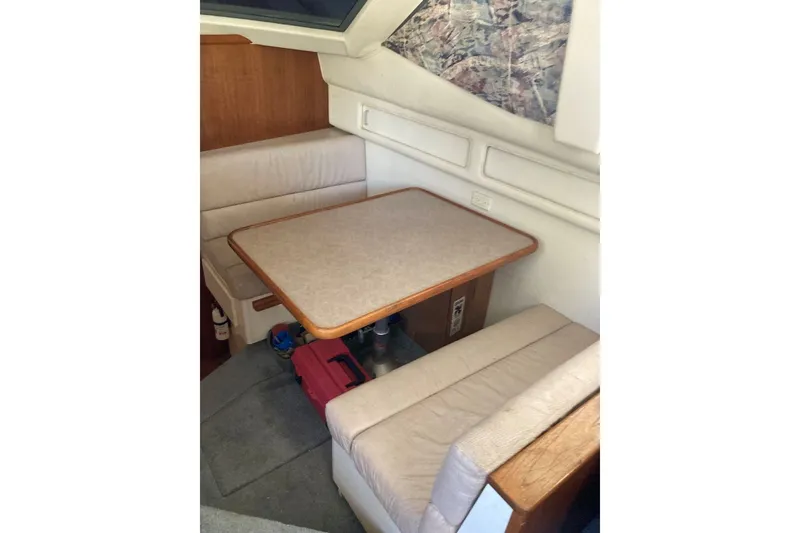 Slide: The Image of 1996 Carver 355 Aft Cabin Motor Yacht interior dining area with cushioned seating. - 16
