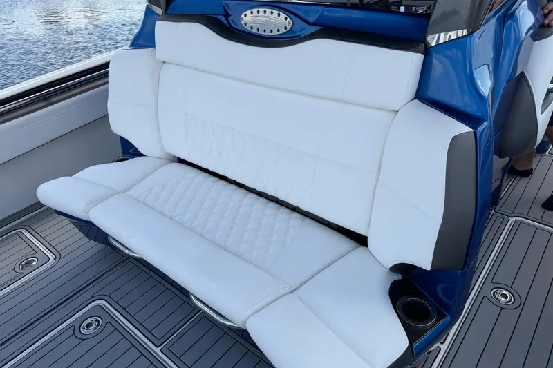 Slide: The Image of Luxurious white seating on a 2020 Nor-Tech boat with blue accents and cup holders. - 15