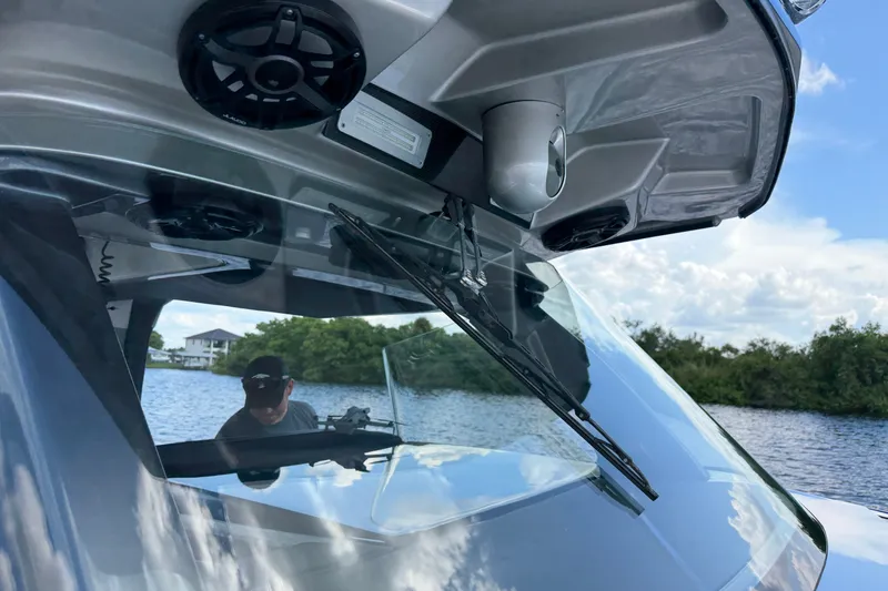 Slide: The Image of 2020 Nor-Tech boat windshield with speakers, on a scenic river backdrop. - 32