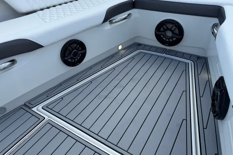 Slide: The Image of 2020 Nor-Tech boat interior with cushioned seating, speakers, and sleek flooring design. - 34