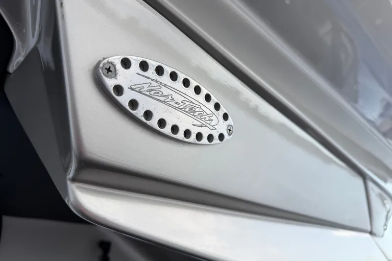 Slide: The Image of Close-up of a 2020 Nor-Tech boat emblem on a sleek metallic surface. - 31