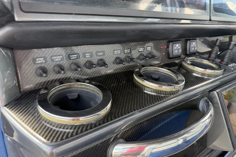 Slide: The Image of Control panel of a 2020 Nor-Tech boat with switches and cup holders. - 18