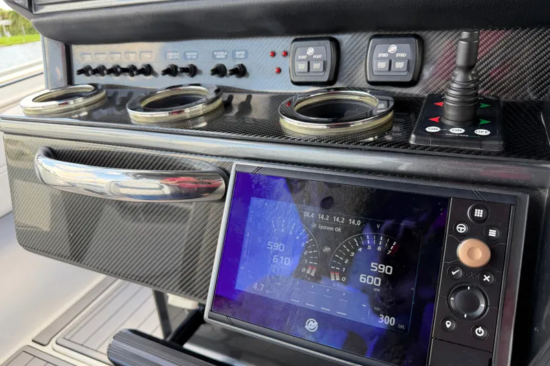 Slide: The Image of 2020 Nor-Tech boat dashboard with digital display and control panel. - 20