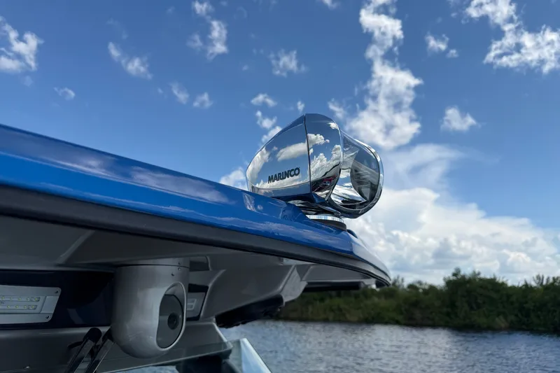Slide: The Image of 2020 Nor-Tech boat with Marinco spotlight against a blue sky background. - 33