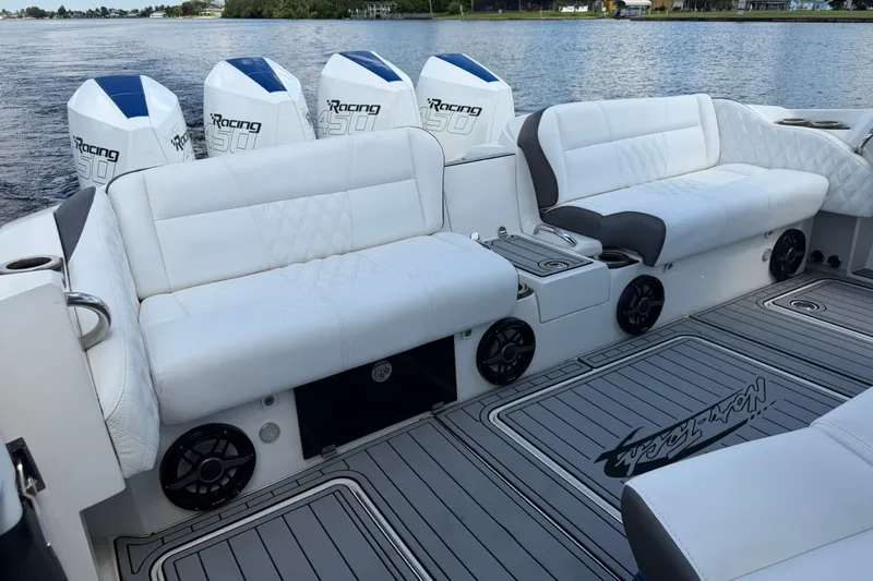 Slide: The Image of Luxurious 2020 Nor-Tech boat interior with white seating and powerful outboard engines. - 14