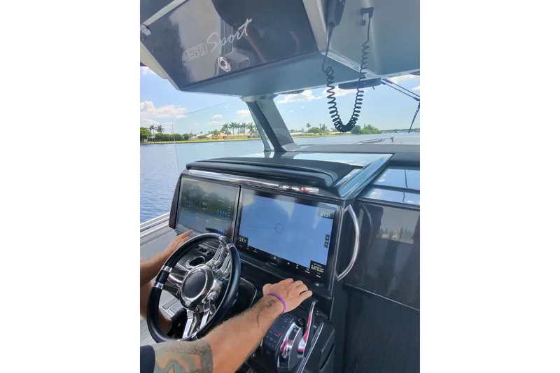Slide: The Image of Cockpit view of a 2020 Nor-Tech 450 Sport boat with advanced navigation system. - 39