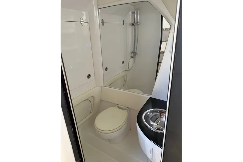 Slide: The Image of 2020 Nor-Tech boat bathroom with toilet, shower, and sink in compact design. - 26