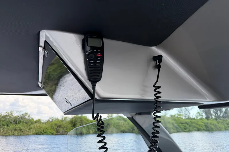Slide: The Image of 2020 Nor-Tech boat interior with mounted radio, overlooking water and greenery. - 30