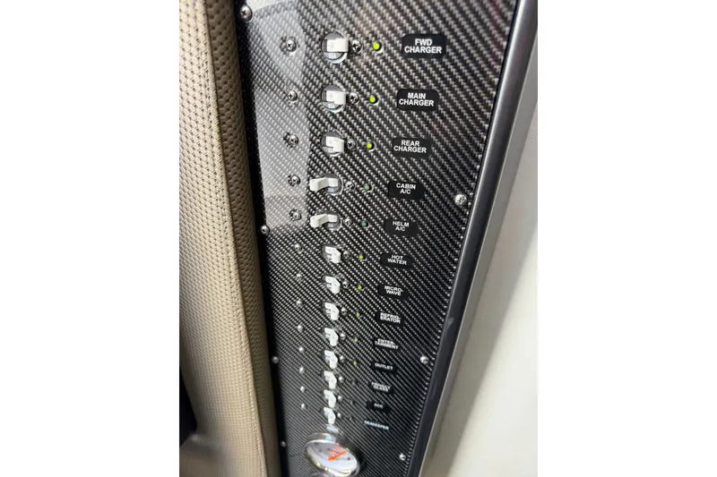 Slide: The Image of Control panel of a 2020 Nor-Tech boat with various switches and indicators. - 21