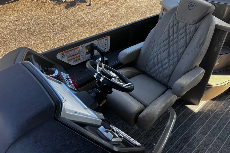 Slide: The Image of Luxurious 2022 Premier Escalante boat interior with leather captain's chair and steering wheel. - 22