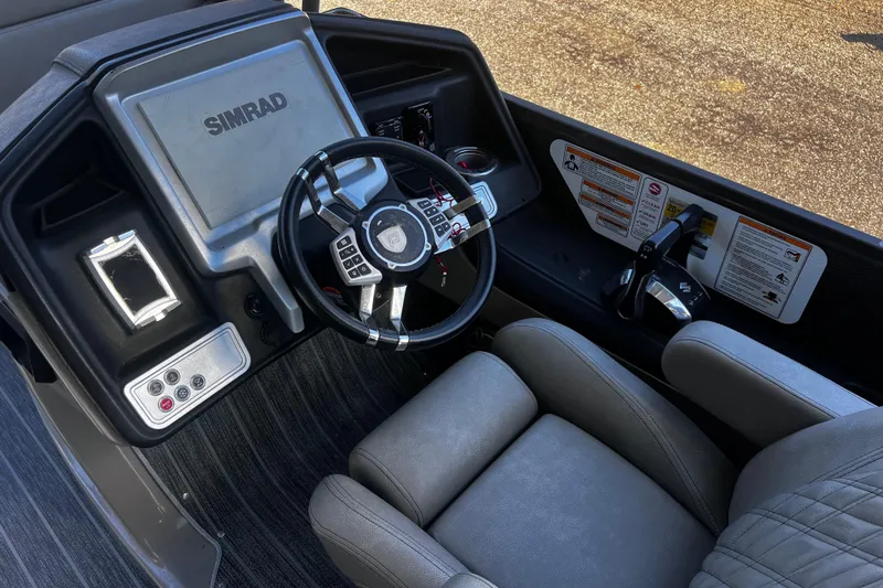Slide: The Image of 2022 Premier Escalante boat dashboard with Simrad display and steering wheel. - 19