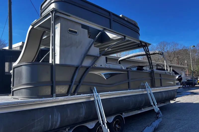 The Image of 2022 Premier Escalante pontoon boat on trailer under clear blue sky. - 6