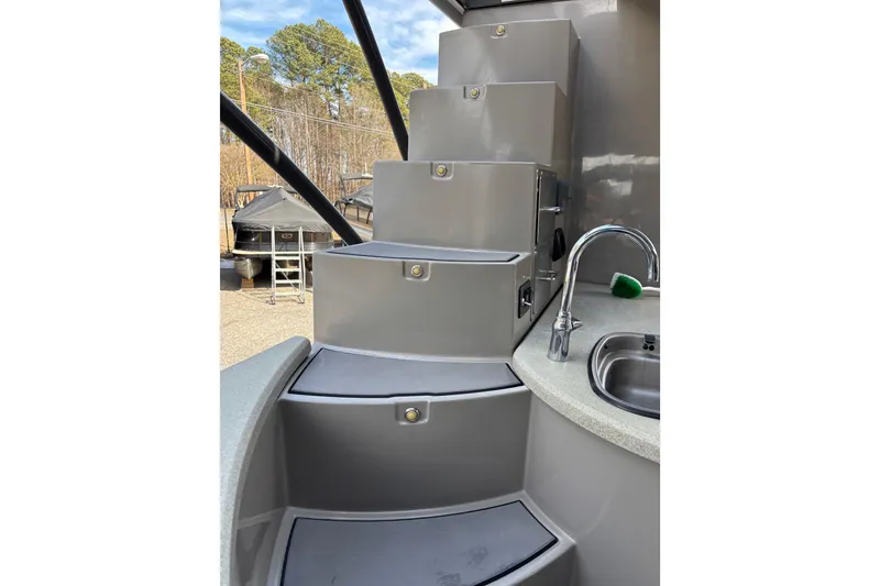 Slide: The Image of Premier Escalante 2022 boat interior with modern staircase and compact sink area. - 31