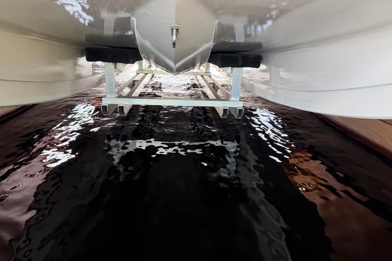 Slide: The Image of Underwater view of 2024 Trick 23 Widebody boat hull on a lift. - 23
