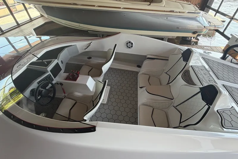 Slide: The Image of 2024 Trick 23 Widebody boat interior with modern seating and hexagonal flooring design. - 18
