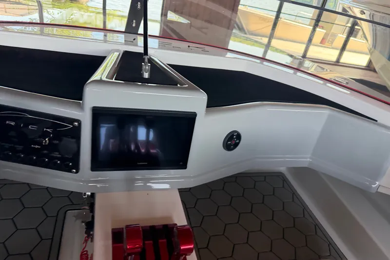 Slide: The Image of 2024 Trick 23 Widebody boat dashboard with modern controls and touchscreen display. - 14