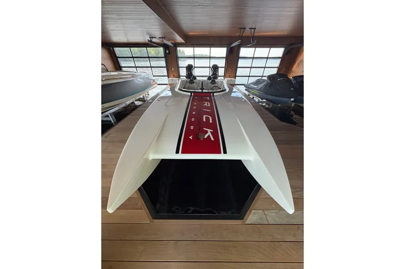 Slide: The Image of 2024 Trick 23 Widebody boat in dock, showcasing sleek design and modern features. - 6