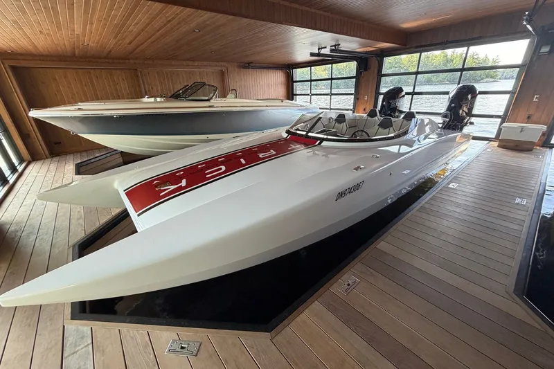 Slide: The Image of 2024 Trick 23 Widebody boat in a wooden boathouse, showcasing sleek design and modern features. - 5