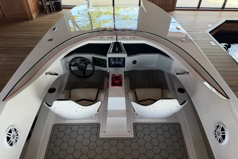 Slide: The Image of 2024 Trick 23 Widebody boat interior with modern dashboard and seating. - 12