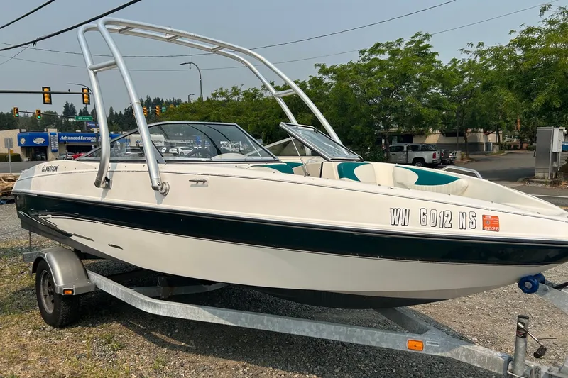 Slide: The Image of 2006 Glastron SX 195 boat on trailer, parked outdoors near street. - 3