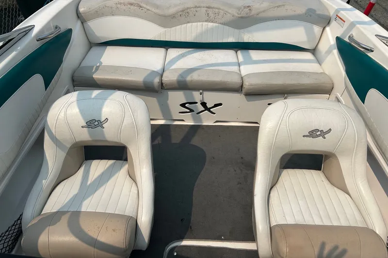 Slide: The Image of 2006 Glastron SX 195 boat interior with white and teal seating. - 8