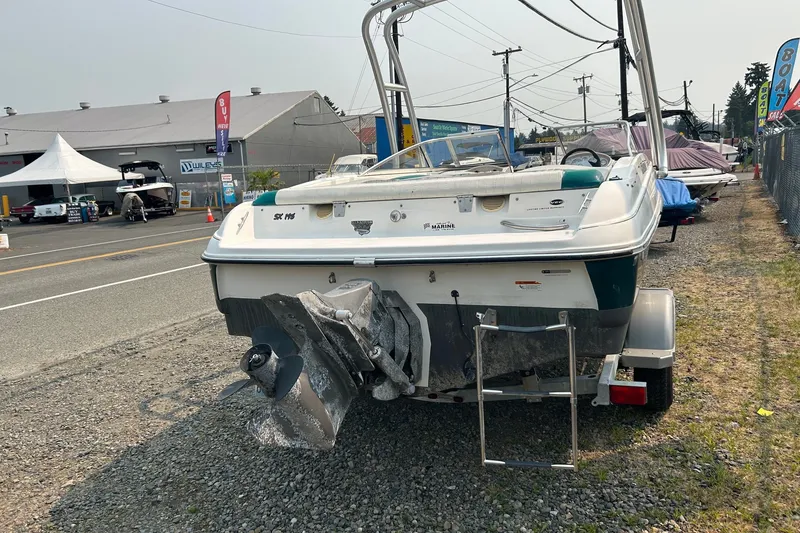 Slide: The Image of 2006 Glastron SX 195 boat on trailer, parked outdoors near dealership. - 2