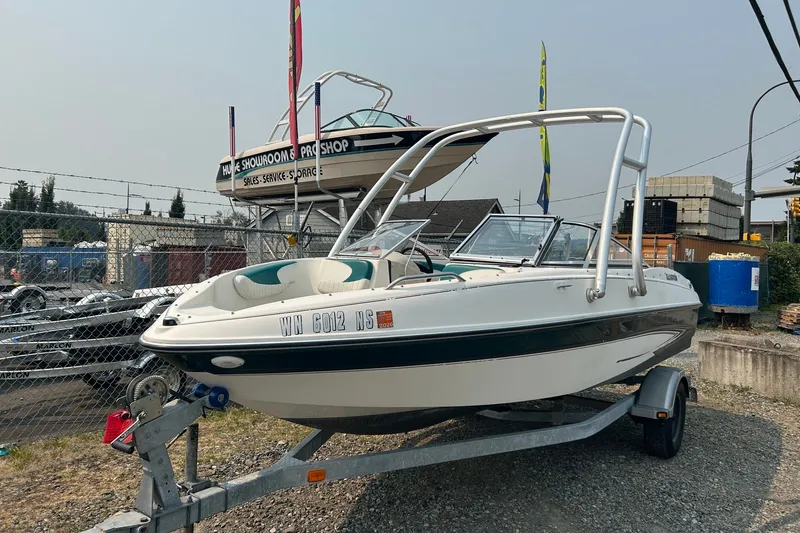 Slide: The Image of 2006 Glastron SX 195 boat on trailer at dealership lot. - 1