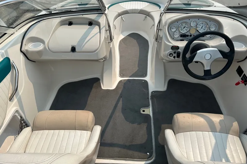 Slide: The Image of 2006 Glastron SX 195 boat interior with steering wheel and dashboard controls. - 6