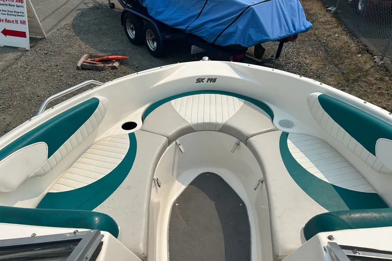 Slide: The Image of 2006 Glastron SX 195 boat interior with teal and white seating. - 9