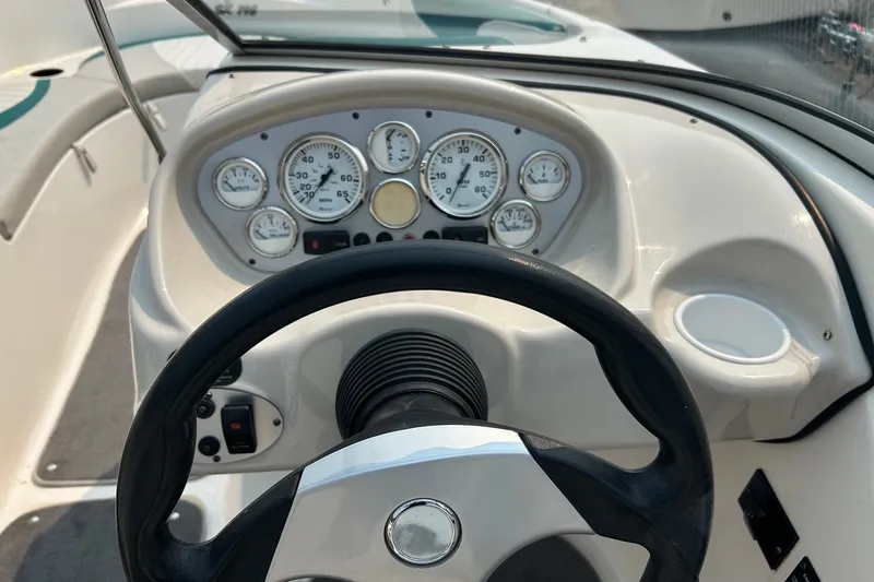 Slide: The Image of Dashboard of a 2006 Glastron SX 195 boat with steering wheel and gauges. - 4