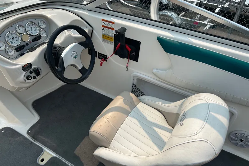 Slide: The Image of 2006 Glastron SX 195 boat interior with steering wheel and dashboard controls. - 5