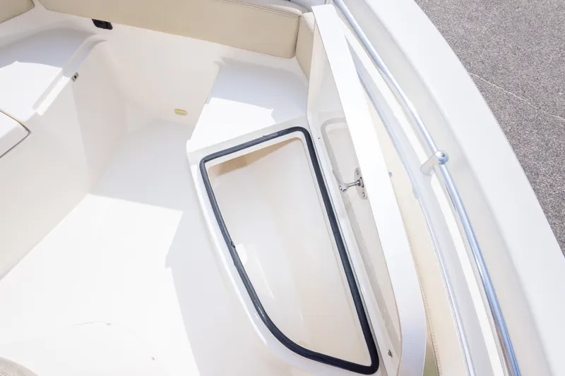 Slide: The Image of 2016 Cobia 201 Center Console boat interior with open storage compartment. - 36