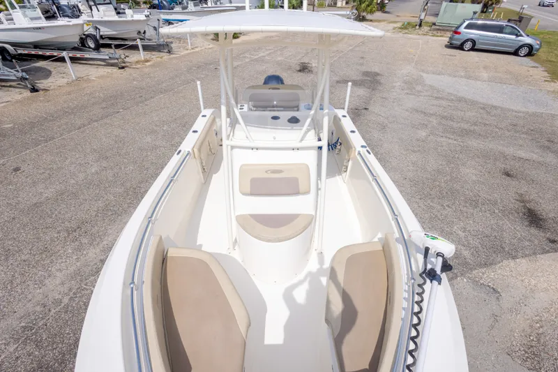 Slide: The Image of 2016 Cobia 201 Center Console boat with seating, parked on a lot. - 32