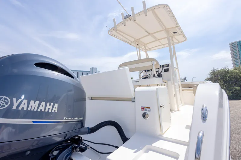 Slide: The Image of 2016 Cobia 201 Center Console boat with Yamaha engine, featuring sleek design and spacious deck. - 20