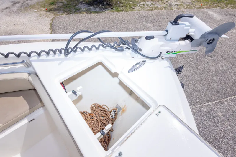 Slide: The Image of 2016 Cobia 201 Center Console boat with anchor storage and trolling motor. - 34